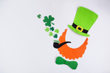 Mask of a handmade leprechaun from paper for a St. Patrick's Day on a white background