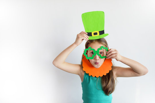 The lovely girl in a mask of a leprechaun for a St. Patrick's Day