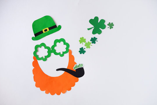 Mask of a handmade leprechaun from paper for a St. Patrick's Day on a white background