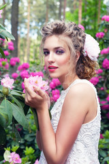 Fototapeta premium girl in dress in rhododendron garden