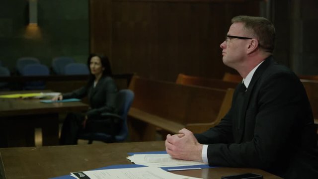 Lawyers in a modern court room arguing a legal case in a judiciary battle in front of a judge