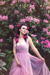 Obraz na płótnie Canvas girl in dress in rhododendron garden