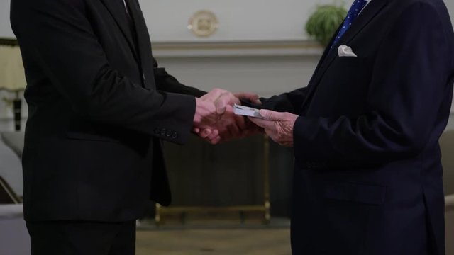 Corruption in politics - man being paid by special interest group in oval office washington white house