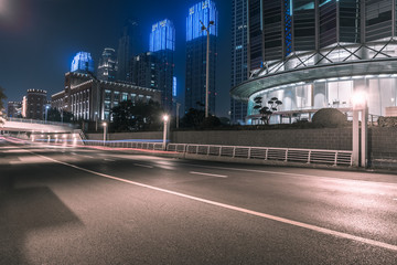 Fototapeta na wymiar empty asphalt road and modern buildings at night