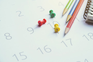close up of calendar and pencils on the table, planning for business meeting or travel planning concept