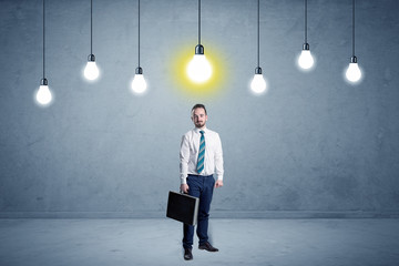 Fototapeta premium Businessman standing uninspired with bulbs above