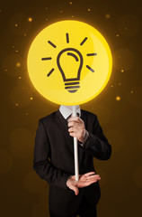 Businessman holding lightbulb sign