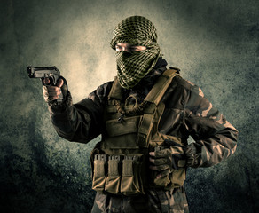 Portrait of a heavily armed masked soldier with grungy background