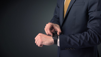 Man in suit wearing smartwatch.