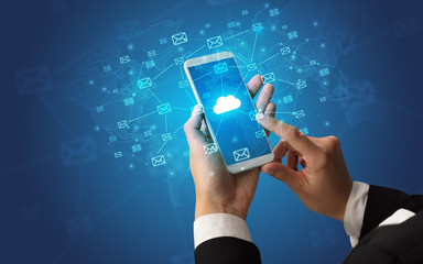 Hand using smartphone with message icons