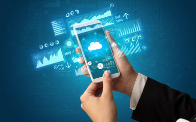 Hand using phone with financial tracking concept