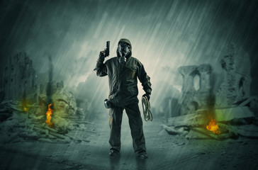 Fototapeta premium After catastrophe men coming in gas mask and arms