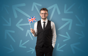 Cheerful boy standing with flag and arrows around