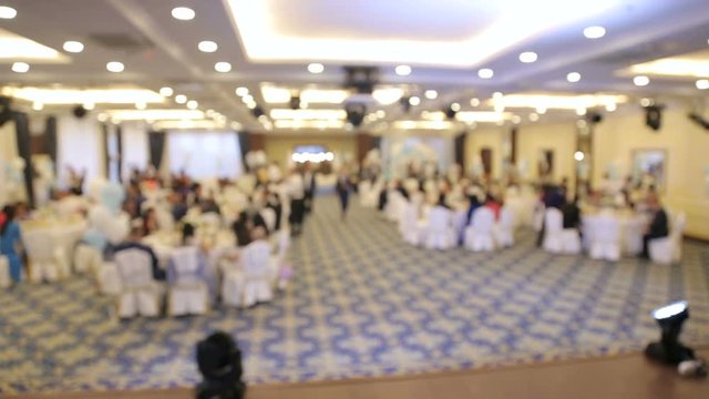 Blurred image of people in the restaurant at the celebration. Restaurant, waiters, celebration, wedding, copy space.