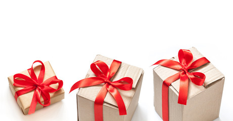 Gift boxes,  three parcels tied with red ribbons. Festive packaging 	
