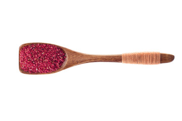 spice Dried sumac in  wooden spoon isolated on a white background, top view