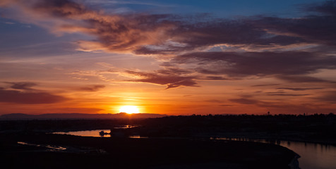 sun setting behind Catalina Island viewed from Newport Beach back bay in California