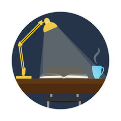 Lamp and light falling on an open book lying on a table.