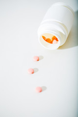 Macro shot of tablets and container