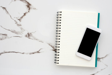 Smart phone with blank screen on blank notebook paper background, mock up, flat lay