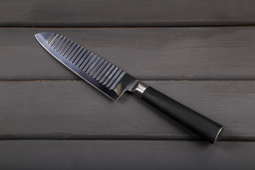 Kitchen knife, cook, chef on a wooden background.