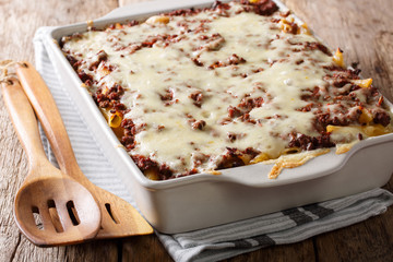 Million dollars pasta casserole with beef meat and cheese in a baking dish close-up. Horizontal © FomaA