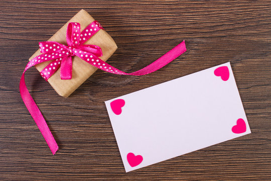 Gift with ribbon and love letter for Valentines Day