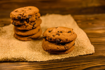 Chocolate chip cookies on sackcloth on a wooden table