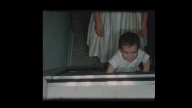 1960 Mother teaches baby boy how to climb steps Reverse