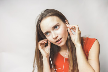 Woman in earphones on a white background