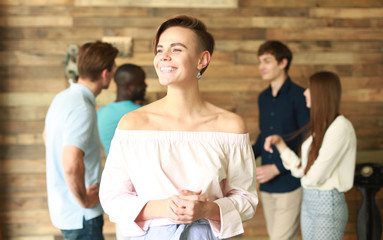 Team leader with coworkers working in office.