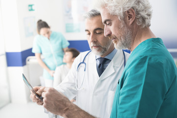 Professional doctors examining patient's x-ray