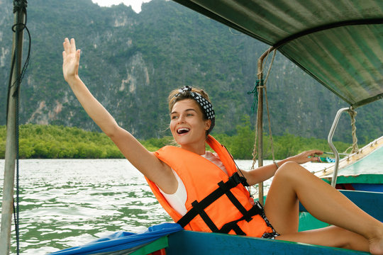 Young woman on the long-tail boat during her vacations in Thailand