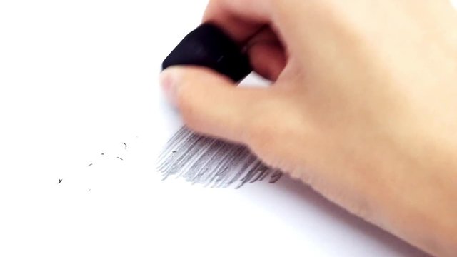 hand using eraser for removing mistake on white paper