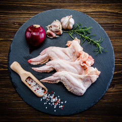 Raw chicken wings wooden background