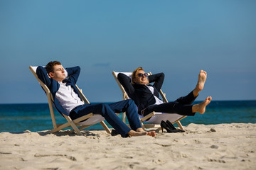Woman and man relaxing on beach
