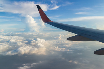 Fototapeta premium View from the wing of the plane Fly over the clouds in the sky.