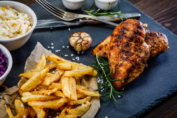Grilled chicken breast, French fries and vegetables