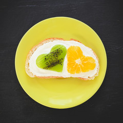 Sandwich with sugar cream and citrus with kiwi fruit. Tasty food. Flat lay, top view