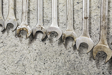 Rack of spanners hung on a wall in a factory unit. Auto repair shop. Industrial scenario. 