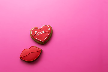Valentine's Day. Biscuits with inscription love in the shape of heart and lips on a pink background.