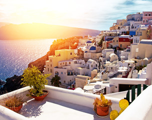 Seaview with with flowers in ceramic pots on the balcony  in the foreground in Santorini, Greece