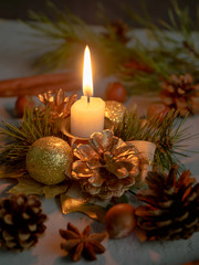 Christmas candles and ornaments over dark background with lights