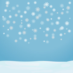 Snowflakes fall on a light blue background. Flying snowflakes fall on the snow.