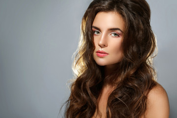 Fototapeta premium Young lovely woman with healthy, beautiful and curly hair