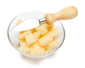Parmesan cheese pieces in glass bowl on white background