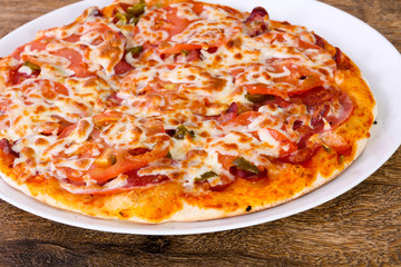 Pizza with sausages and tomato