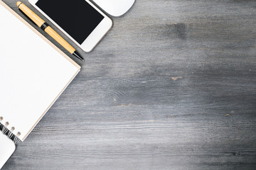 Table with empty smartphone and supplies