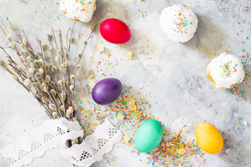 Easter background. Colorful background of Easter with colored eggs on a concrete background with copy space. Flat lay. Top view with copy space.