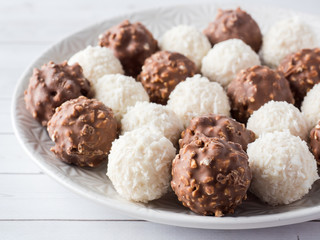 Chocolate and Coconut Candy on a Plate of White background